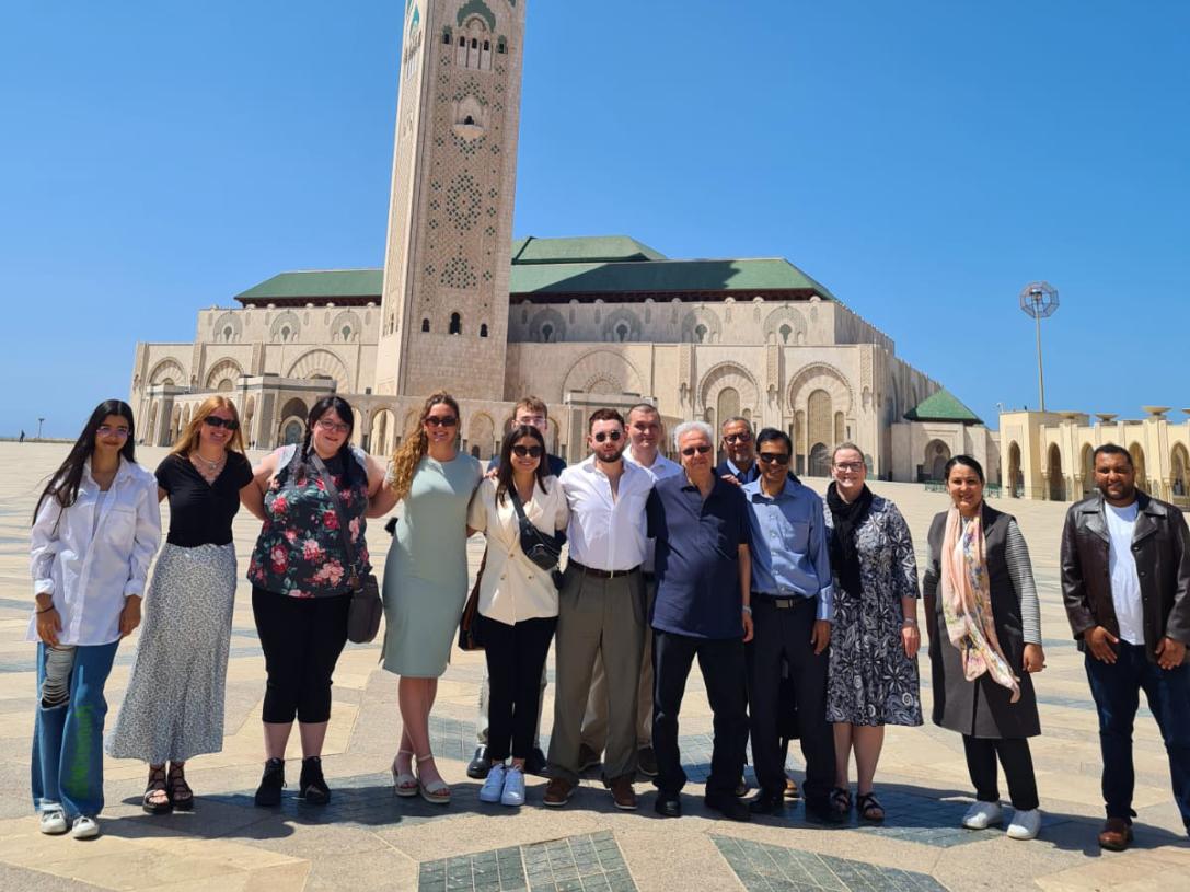 Group shot in front of the Hassan II Mosque in Casablanca, Morocco.