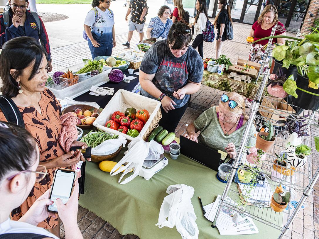 Vendors and wait on customers at the Plowshares Mobile Market