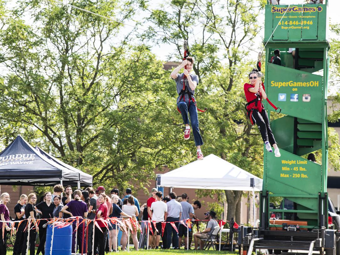 Two Dons race down the zipline at the annual Picnic on the Lawn on Sept. 7.