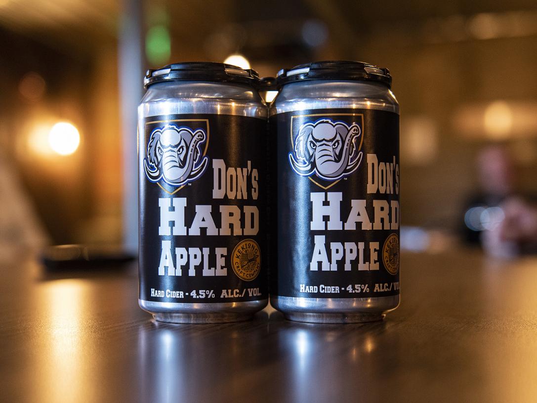 Two cans of Don's Hard Apple Cider