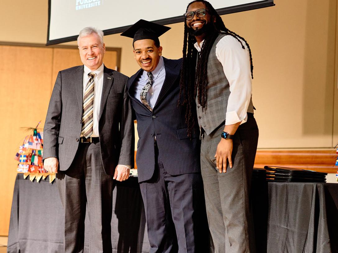 Chancellor Ron Elsenbaumer, graduate Kendall Cox, and Chief Diversity Officer MarTeze Hammonds.