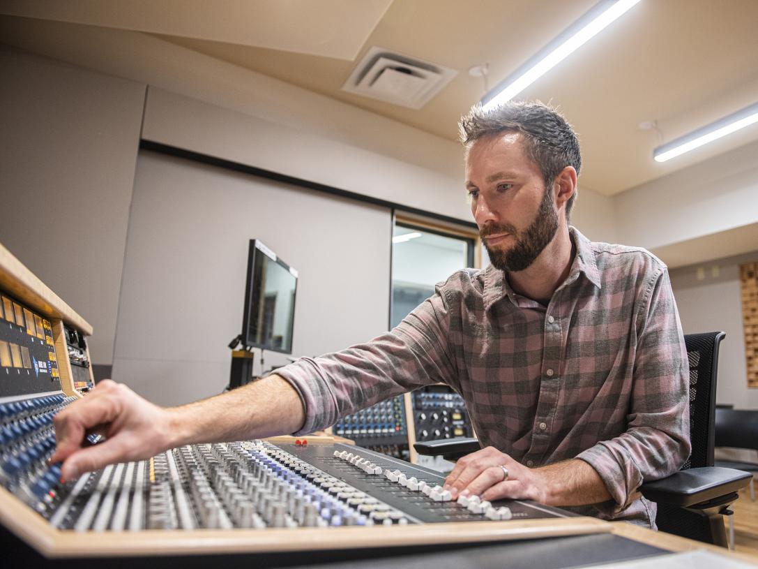 John Buteyn is working at a sound board
