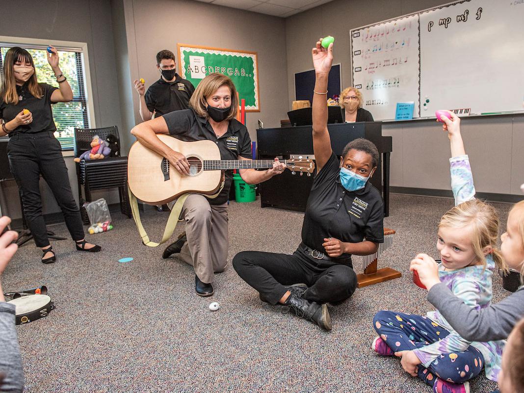 Music therapy students work with young clients.