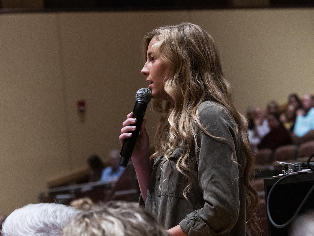 PFW political science student Caymbria Brown asks a question from the audience for Judy Woodruff.