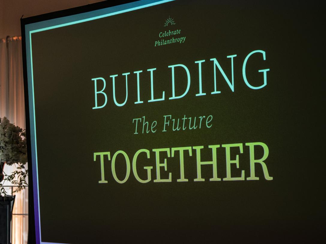 Powerpoint slide at the Celebrate Philanthropy dinner that says "Building Together"