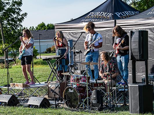 The band Man of the Flood is performs for an audience.