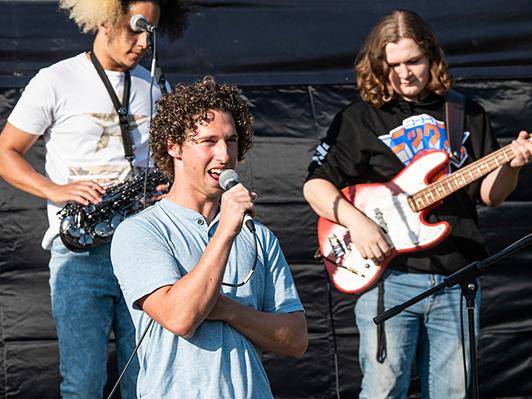 A member of the band Man of the Flood is singing into a mic.