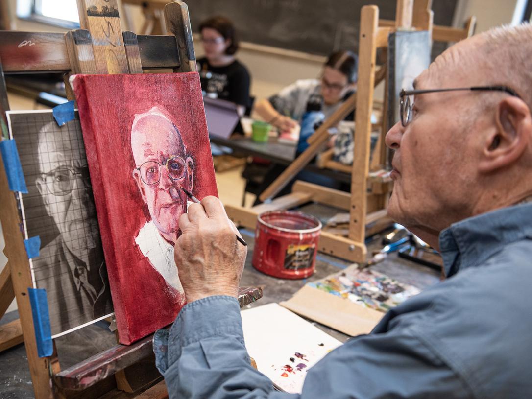 Alan Grinsfelder is painting his self portrait.