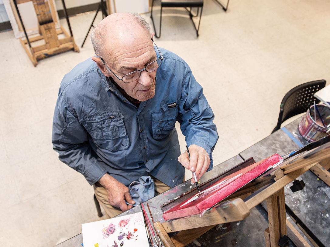 Alan Grinsfelder is painting a portrait