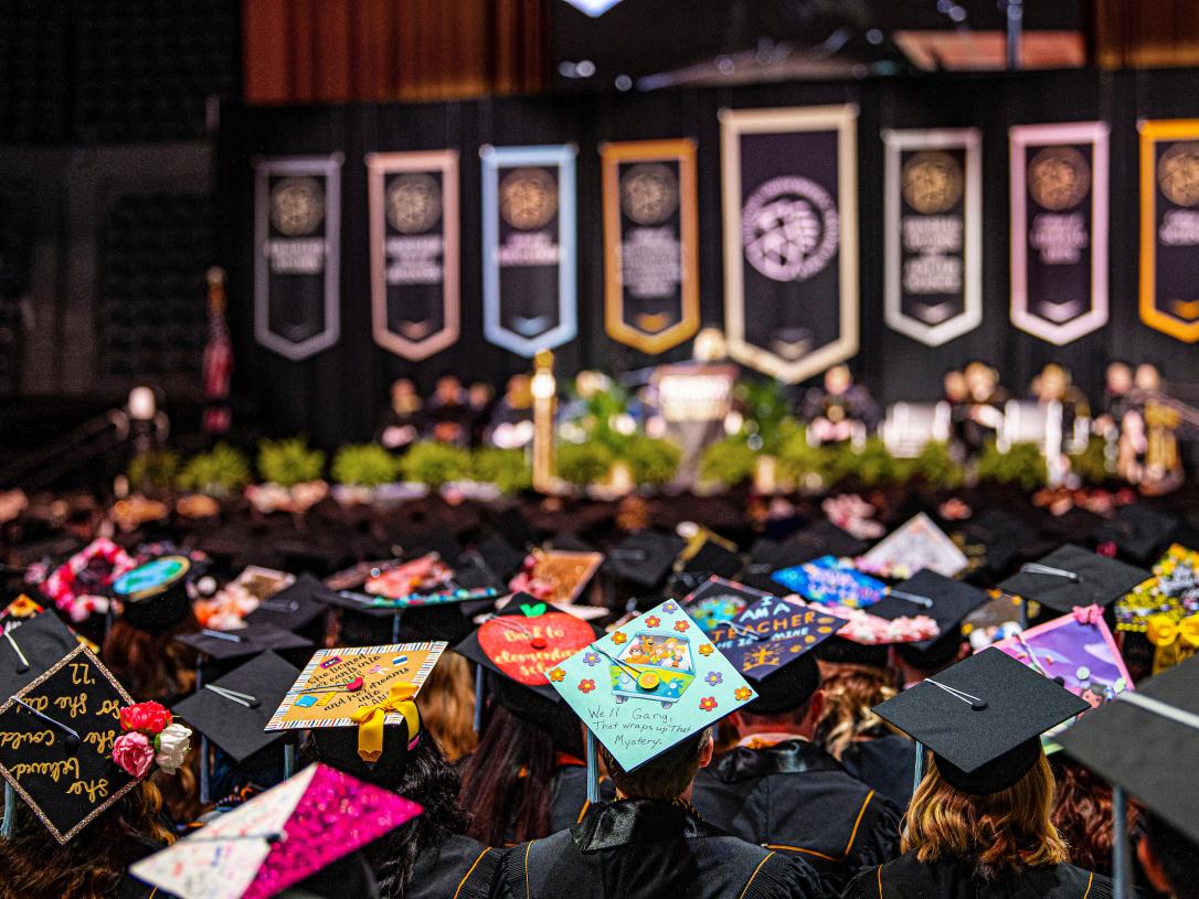 Crowd shot of decorated caps during the 2022 commencement.