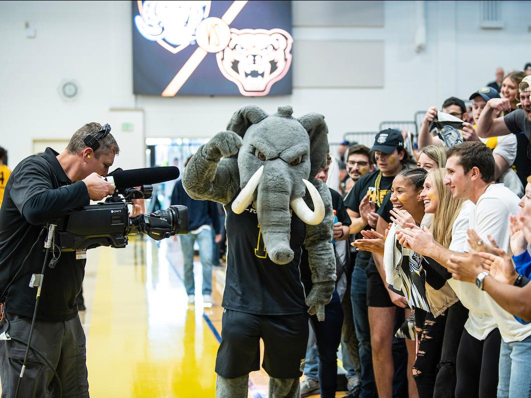 Don flexes his muscles in front of an ESPNU camera