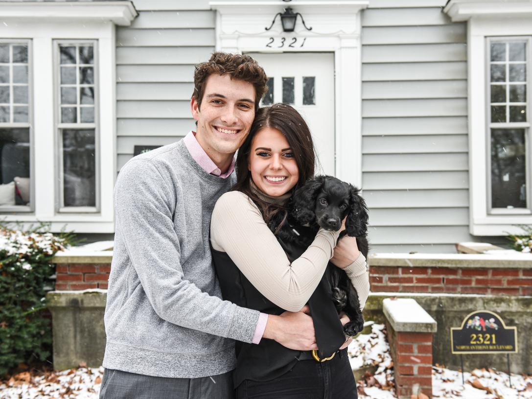 Julia Green and her husband are standing in front of their home