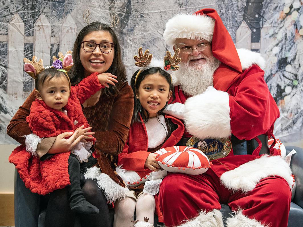 Student Honey Fender and her two daughters at the Jingle Jubilee event