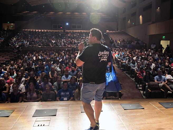 James Velez is speaking to new students in the Auer Performance Hall
