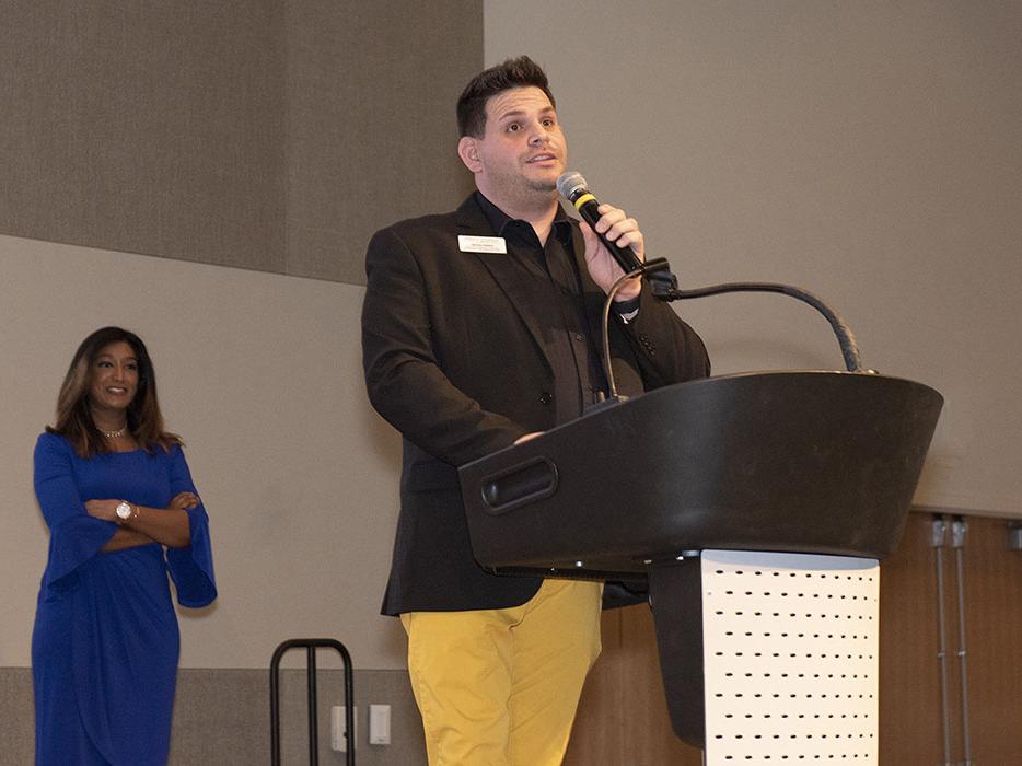 James Velez is speaking at a lectern