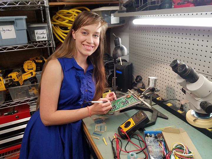 Chantelle Huebner is soldering a circuit board