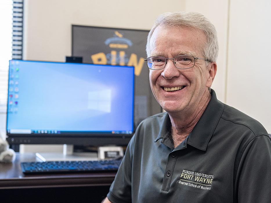 Mike Slaubaugh is sitting in front of his computer