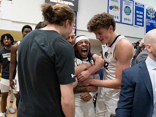 Teammates congratulate Damian Chong Qui after his game-winning shot