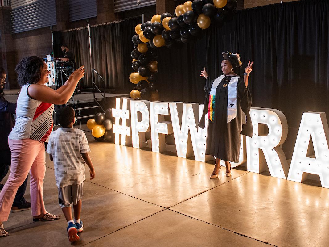 A new PFW graduate poses for a photo.