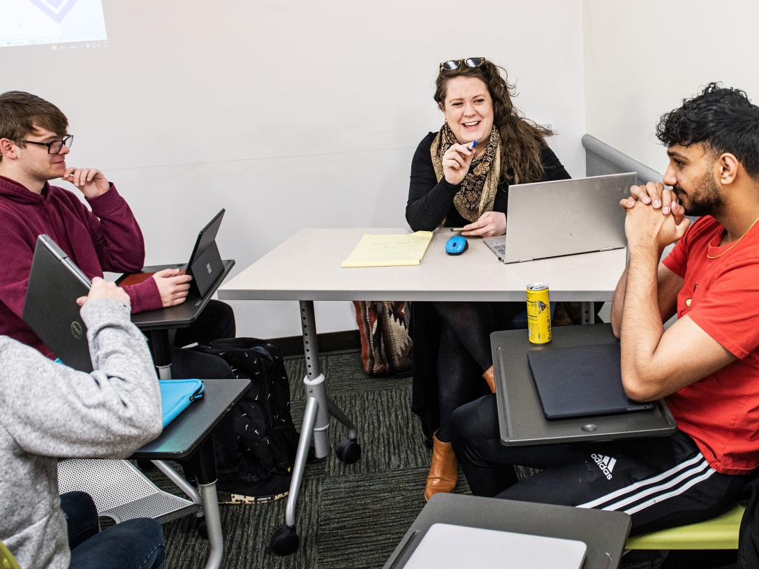 Erin McCarthy meets with students in an English 131 class.