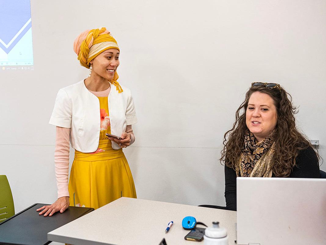 Mary Encabo-Bischoff and Erin McCarthy in a classroom seetting.