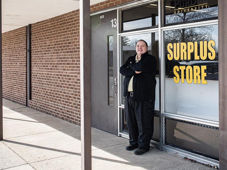 Marcus Tulley is standing next to the Surplus Store entrance