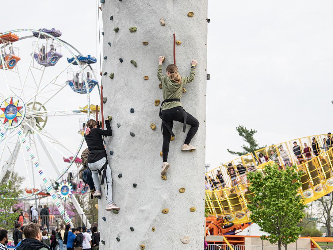 Students are on a rock-climbing wall at Mastodons Big Night