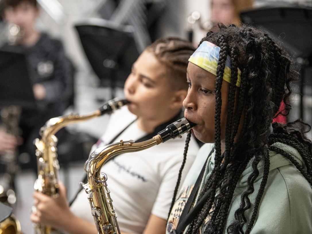 Fusion Band students are playing their saxophones