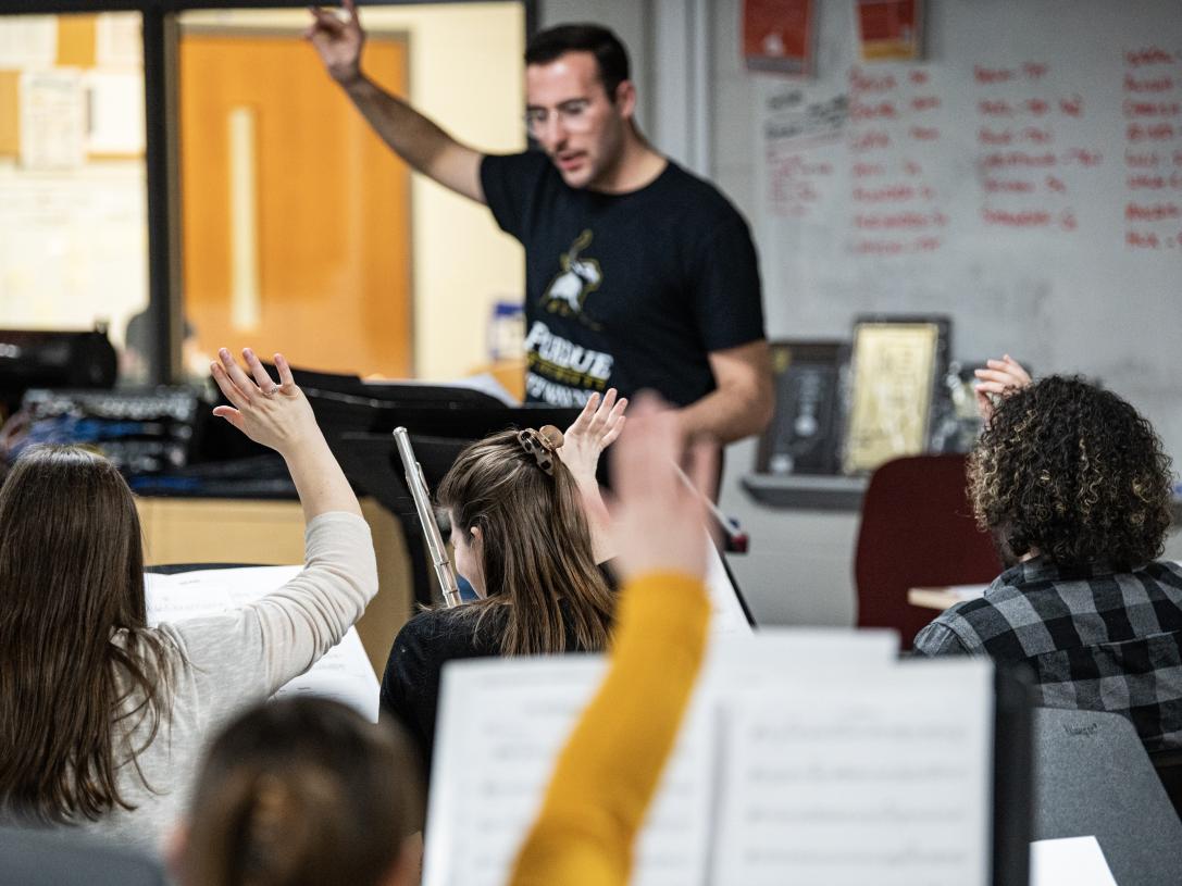 Senior music education student Ethan Hacker conducts the Fusion Band.
