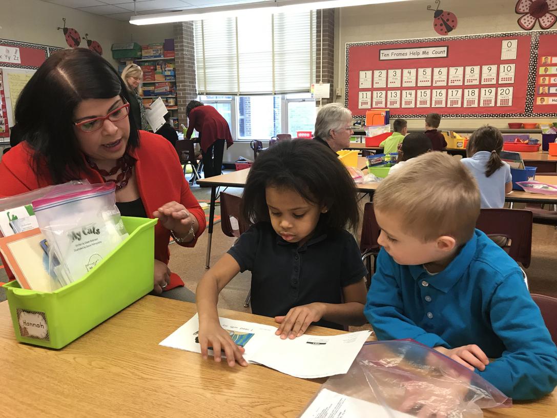 Maria Norman is working with elementary school students.