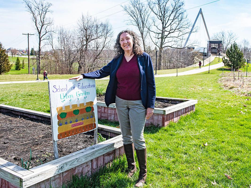 Julie Smith is standing next to a garden bed