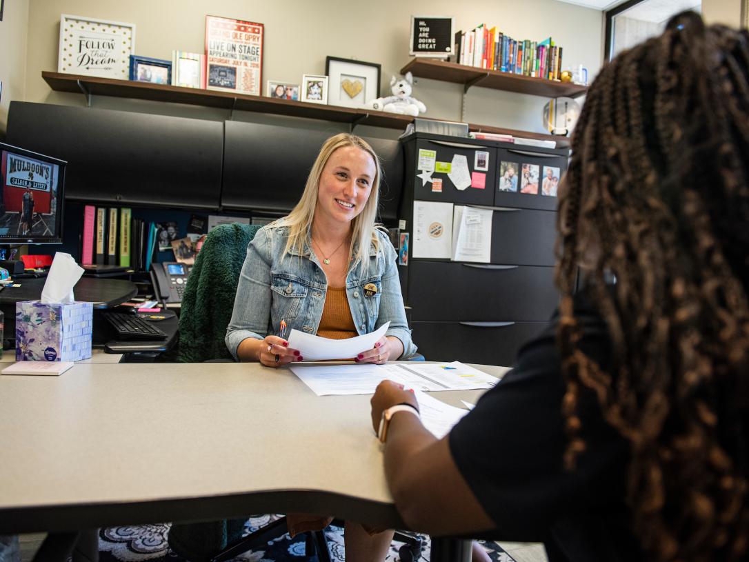 Staff member helping student