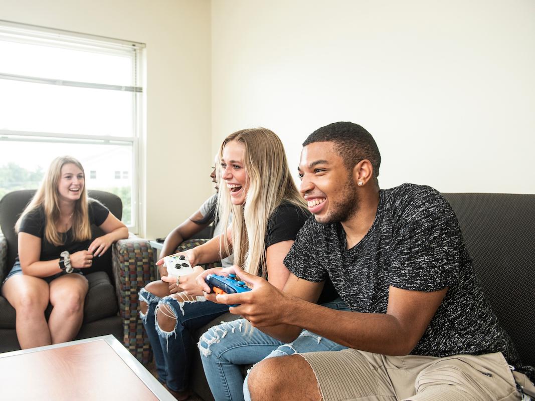 Students on a couch in housing.