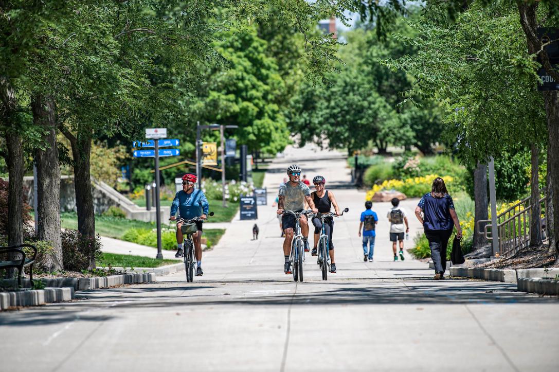 Cyclists ride through campus on the trails.