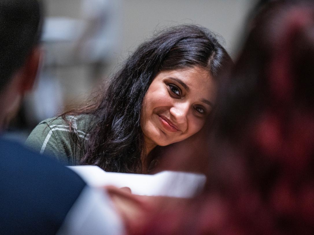 A student smiles toward the camera during orientation.