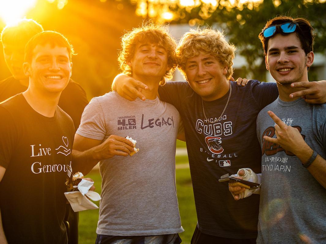 Students pose for a photo holding s'mores during campus kickoff.