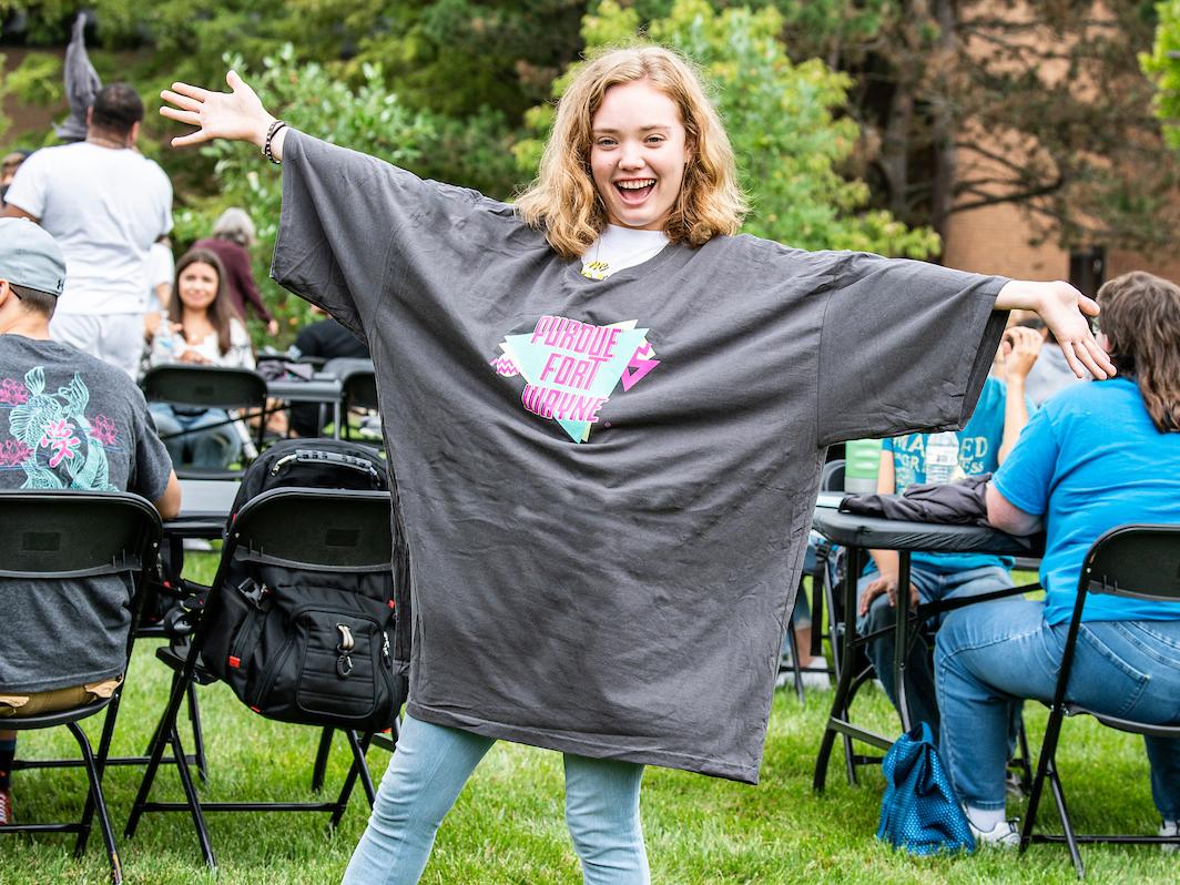 A student shows off their oversized PFW t-shirt at Campus Kickoff.