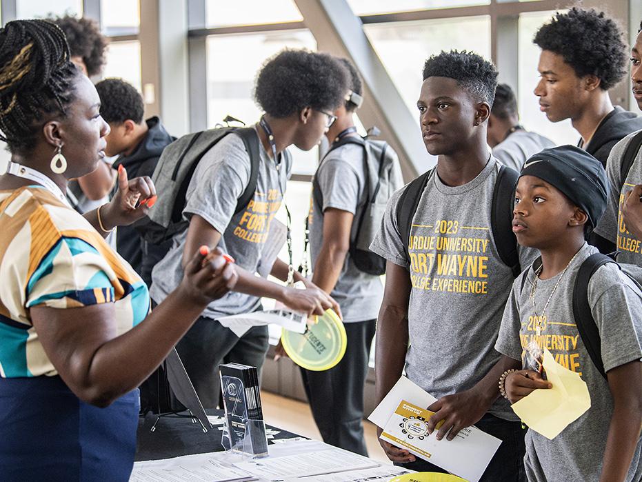 Young participants of the College Experience gather information at the end of a day of workshops