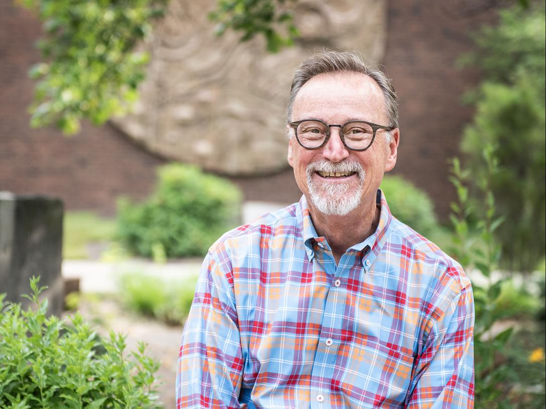 Portrait of Wylie Sirk in front of Neff Hall.
