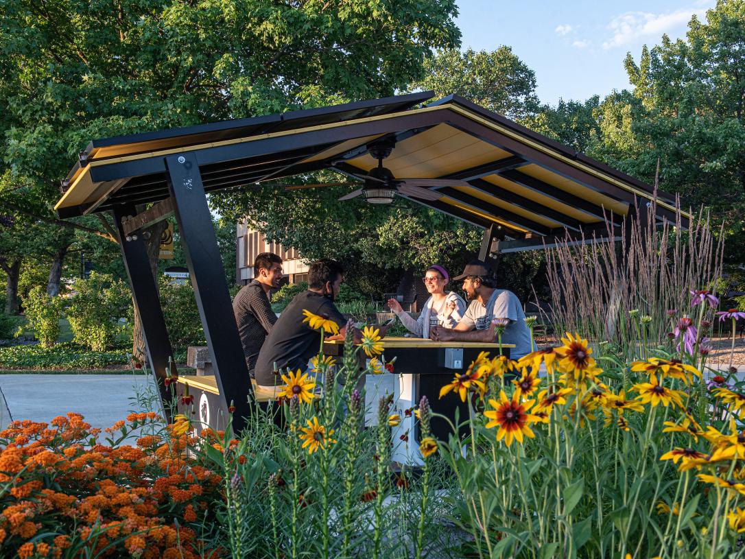 Students sitting in the solar hut