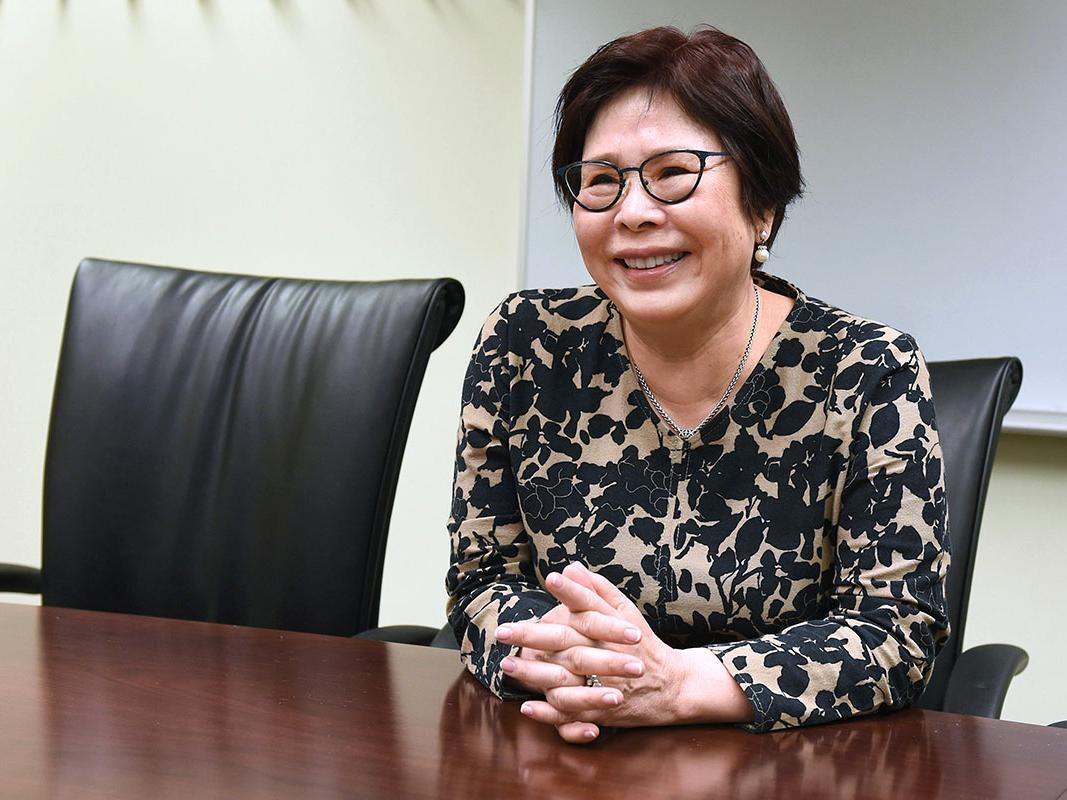 Portrait of Sheena Choi sitting at a desk