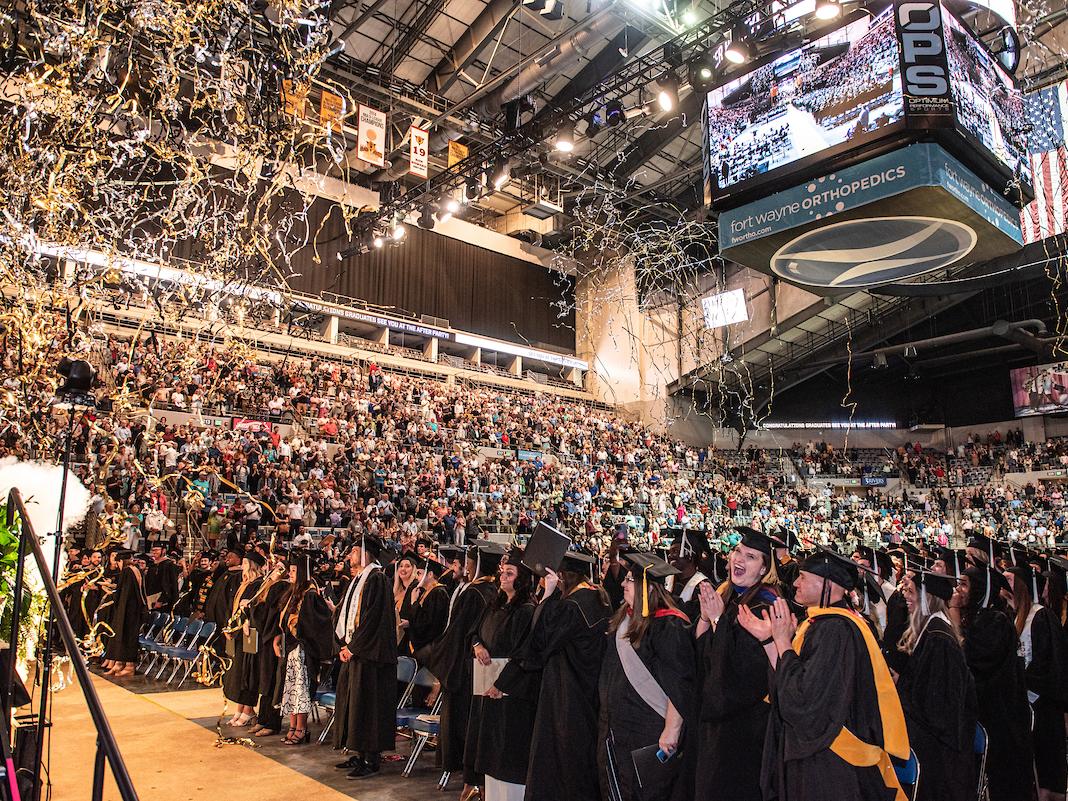 Students clapping during the graduation ceremony.