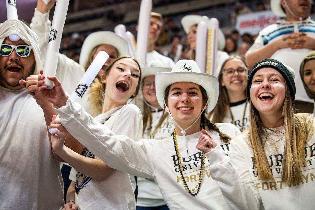 Students in white PFW sweatshirts at the homecoming game.
