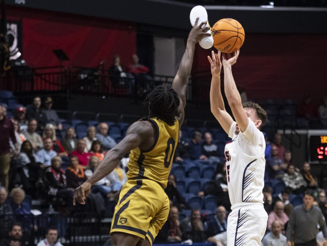 Rasheed Bello blocks a shot with his shoe (photo courtesy of MaCabe Brown of the Evansville Courier & Press)