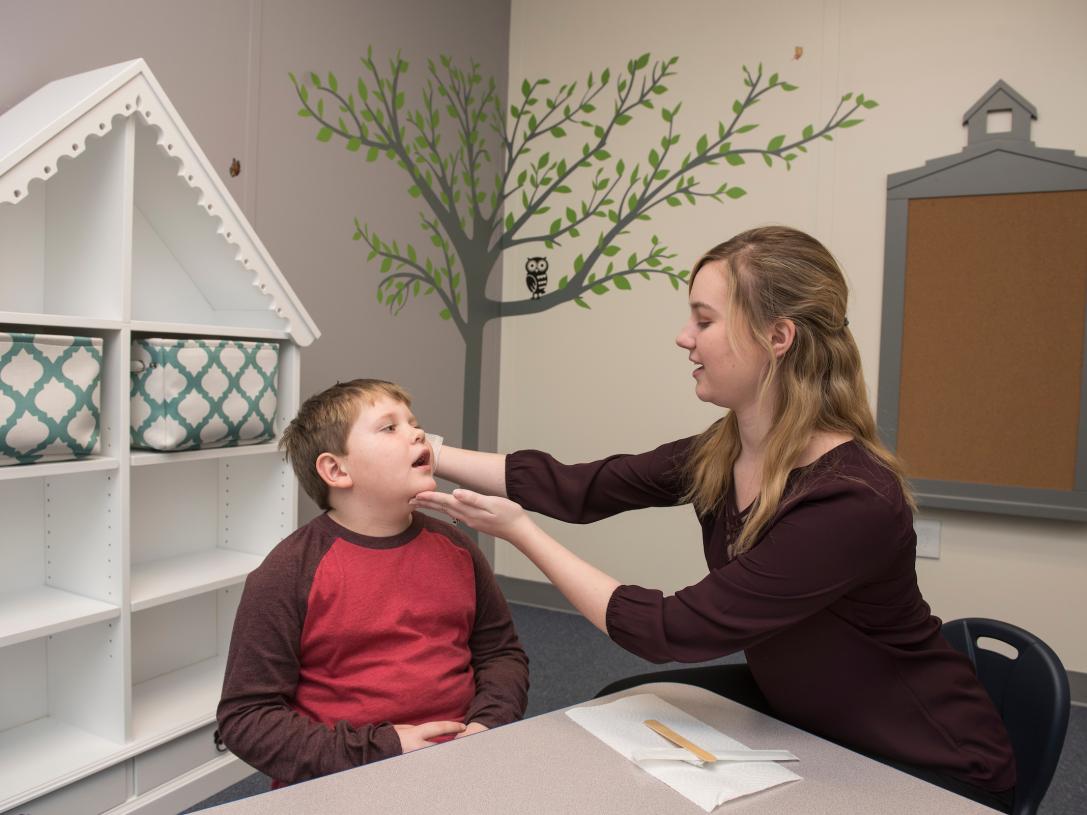 Speech language pathologist working with patient