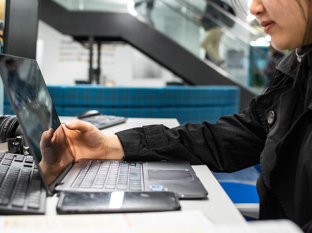 Student working on a computer in the library