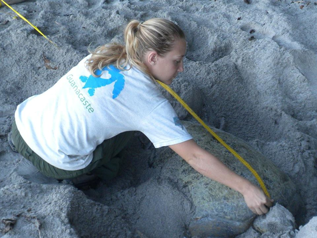 Woman measuring a sand pit