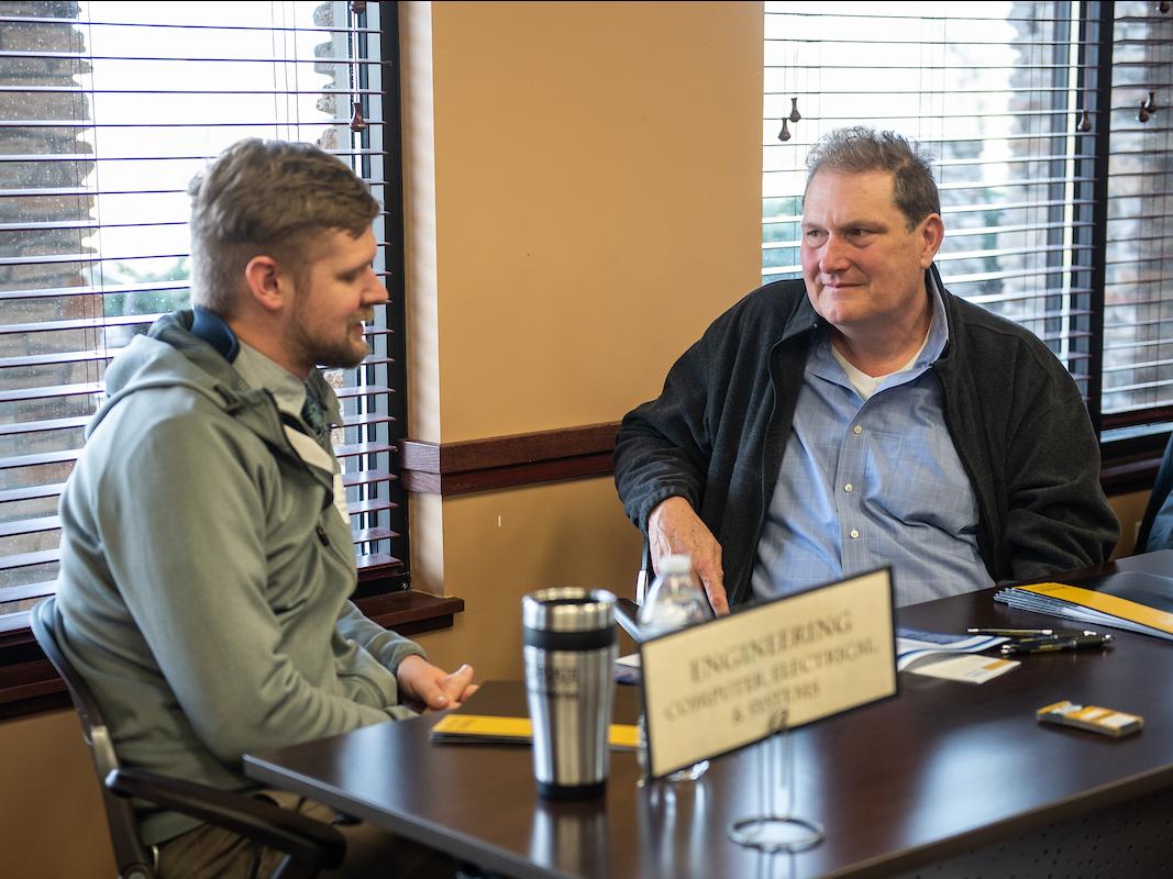 David Cochran talking to a student