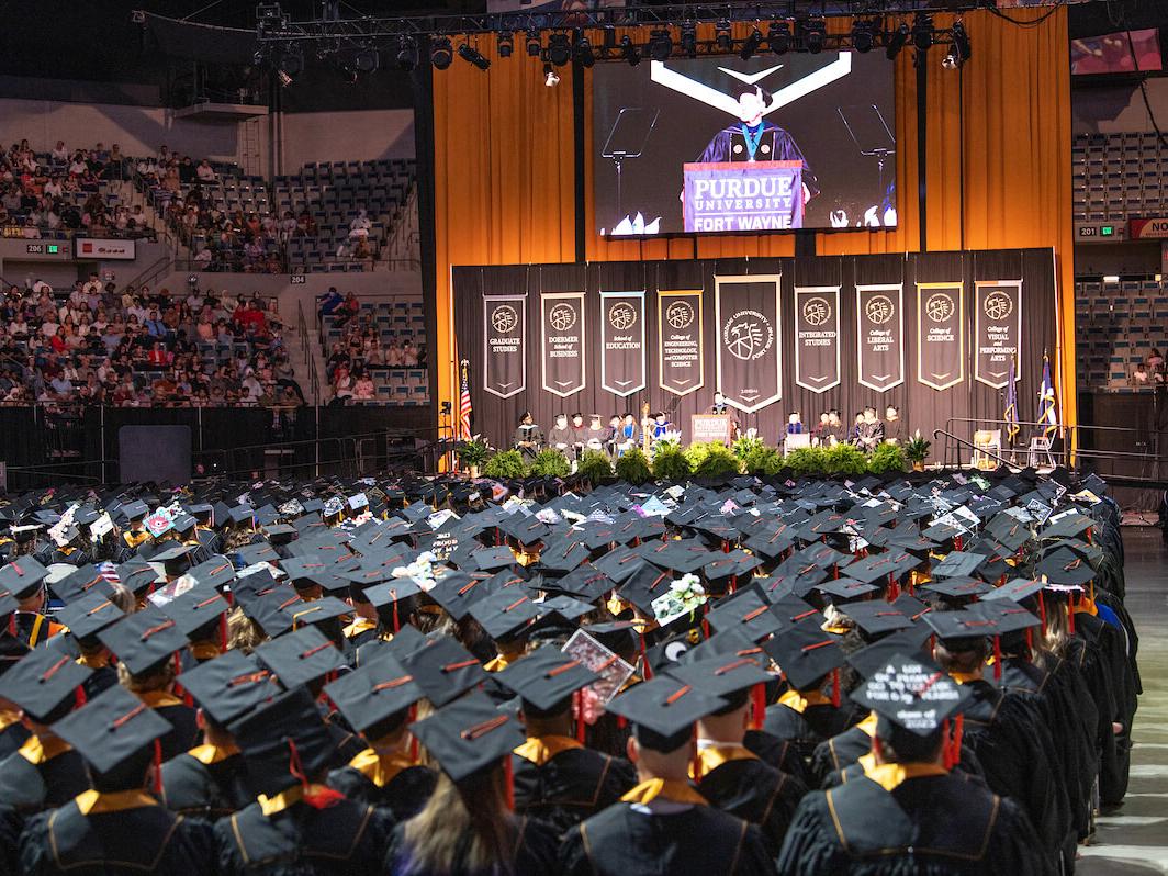 Soon-to-be graduates listen attentively to remarks delivered by Chancellor Ron Elsenbaumer during Purdue University Fort Wayne's 2023 Commencement.