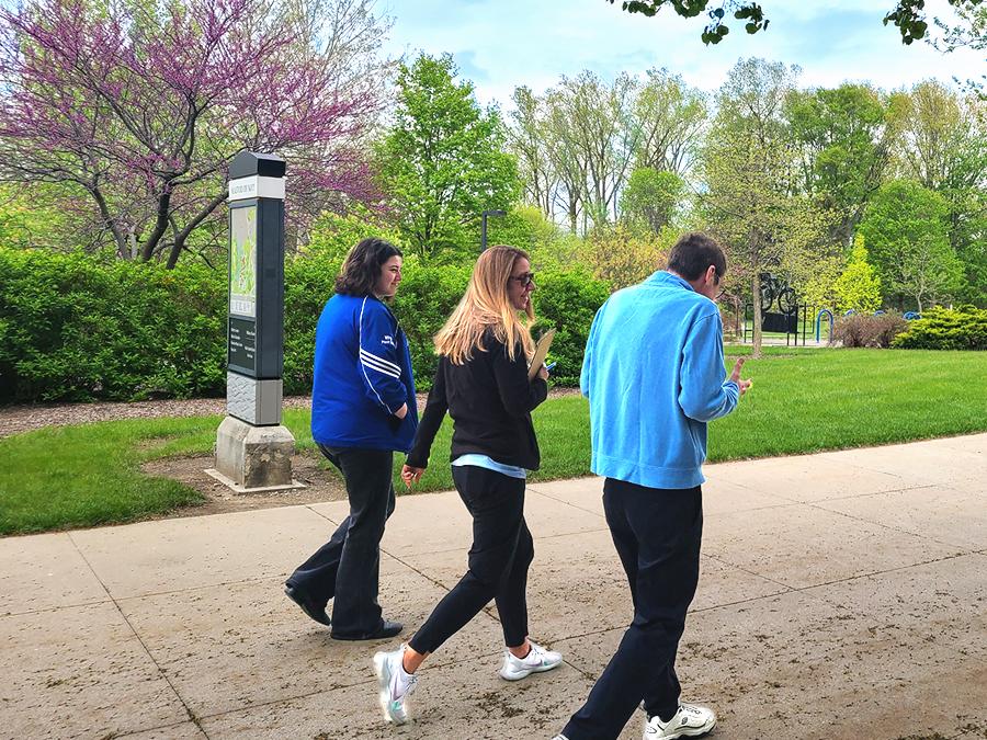 Health Coach walking on campus with members of faculty and staff.